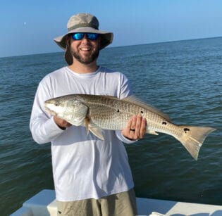 Angler holding redfish