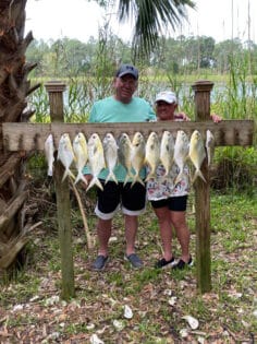 Happy couple with fishing catches