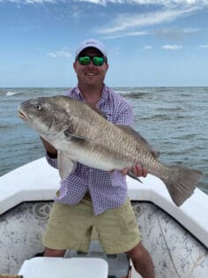 Man holding his catch from fishing charter