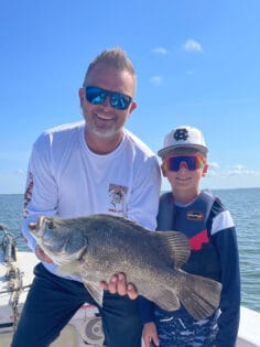 Son and Dad holding tripletail catch