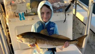 Young boy holding catch